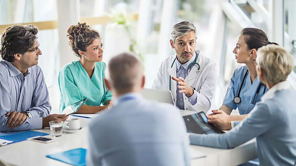 Team of doctors and business people talking on a meeting at doctor's office